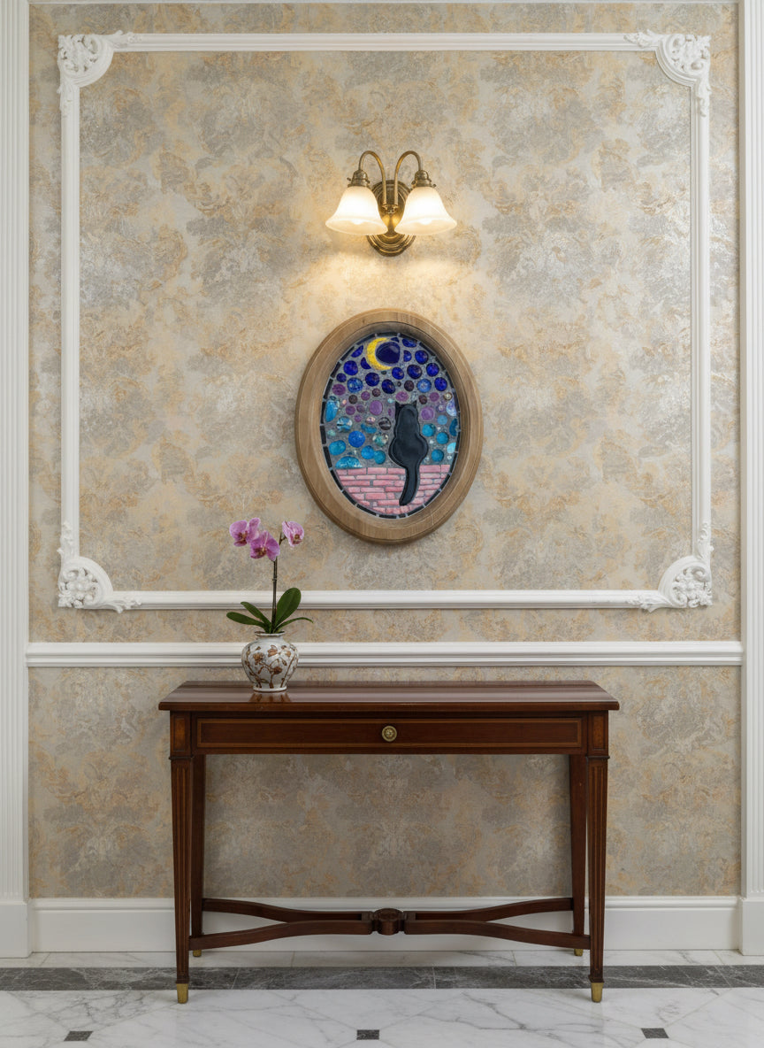 Handmade mosaic wall art by Northeast Georgia artist Sarah Campbell, featuring a black cat sitting on a pink brick wall under a crescent moon with stained glass and colorful gems in an oval frame.